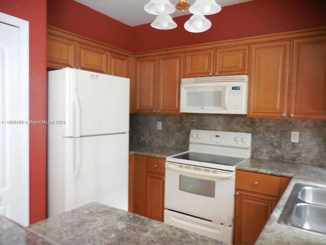 kitchen with white appliances, sink, and tasteful backsplash