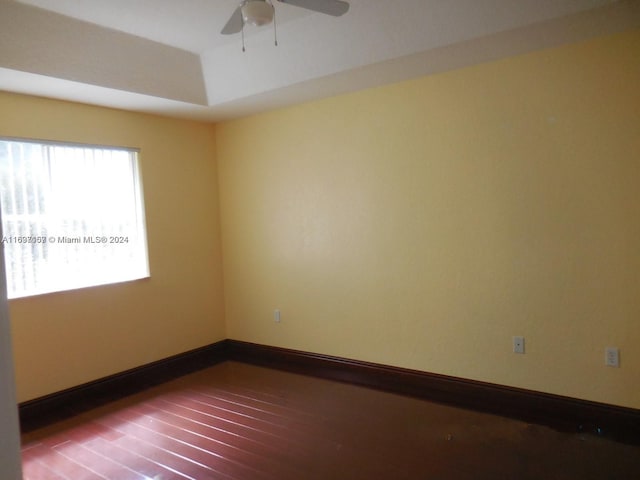 spare room with hardwood / wood-style floors and ceiling fan