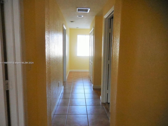 hallway featuring light tile patterned floors