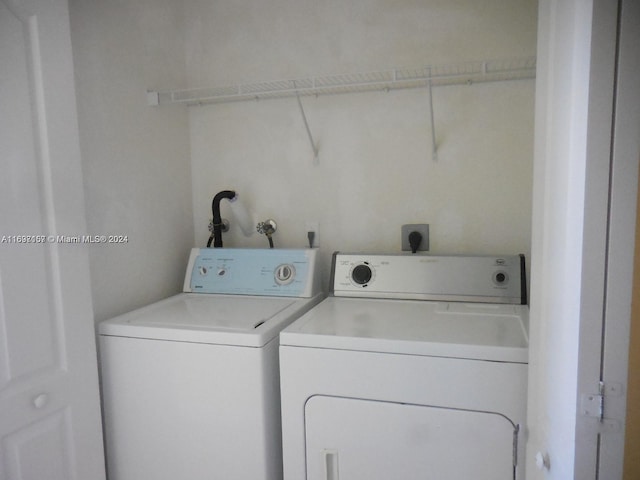 clothes washing area with separate washer and dryer