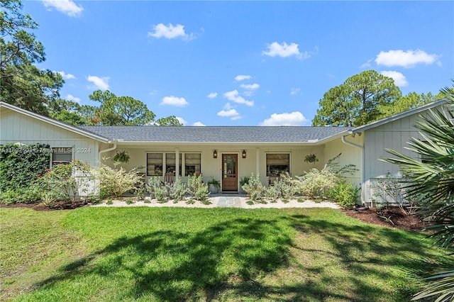 single story home with a porch and a front yard