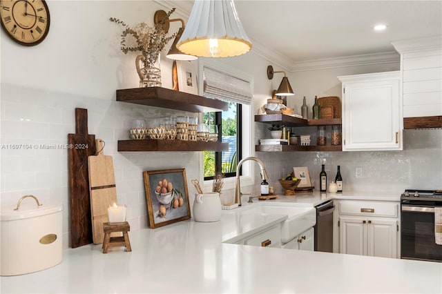 kitchen with white cabinets, backsplash, sink, and stainless steel appliances