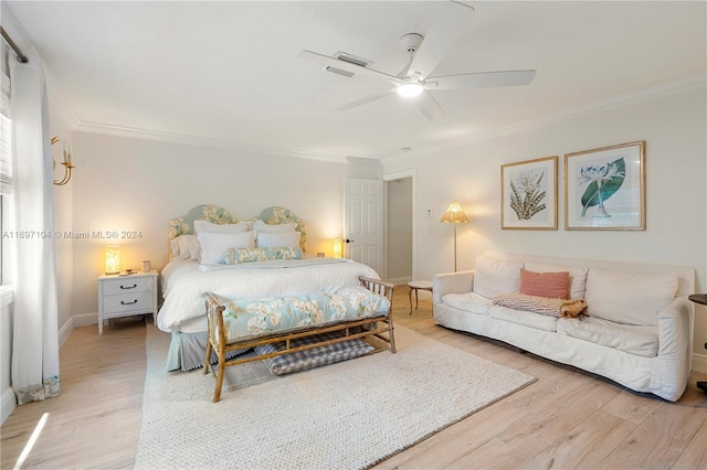 bedroom with ceiling fan, crown molding, and hardwood / wood-style flooring