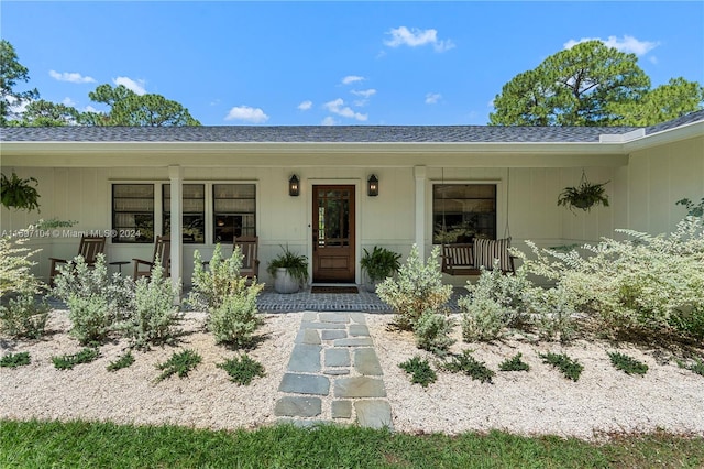 doorway to property with covered porch