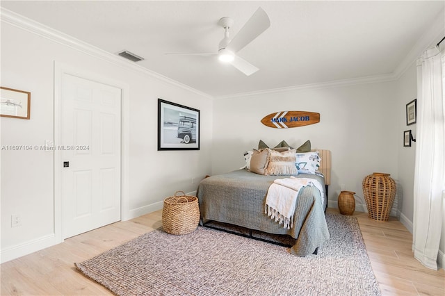 bedroom featuring hardwood / wood-style floors, ceiling fan, and crown molding