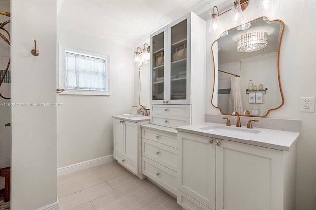 bathroom with a shower with curtain, vanity, and ornamental molding