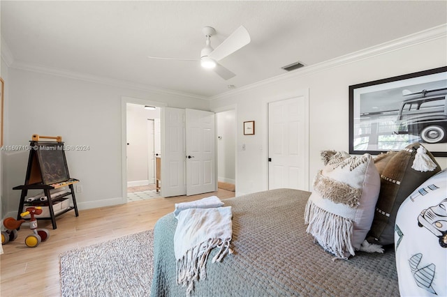 bedroom featuring hardwood / wood-style floors, ceiling fan, and ornamental molding