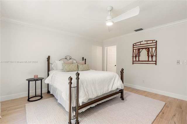 bedroom featuring ceiling fan, crown molding, and light wood-type flooring