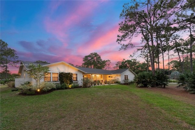 ranch-style home with a lawn