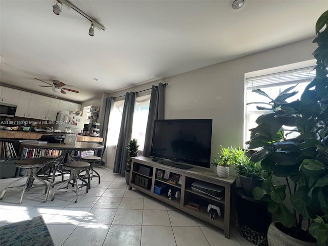 dining area featuring light tile patterned floors, ceiling fan, and a healthy amount of sunlight