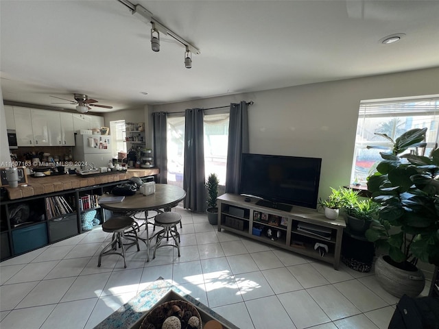 dining area featuring ceiling fan, light tile patterned floors, a healthy amount of sunlight, and track lighting