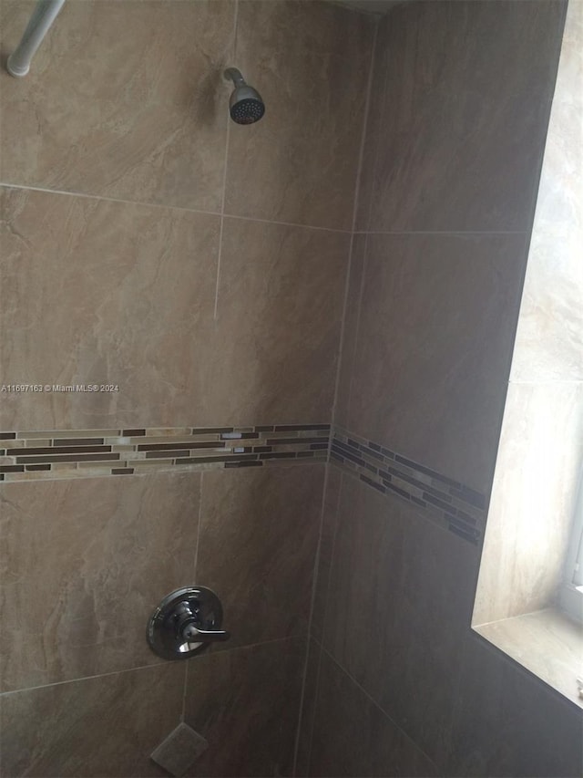 room details with a tile shower