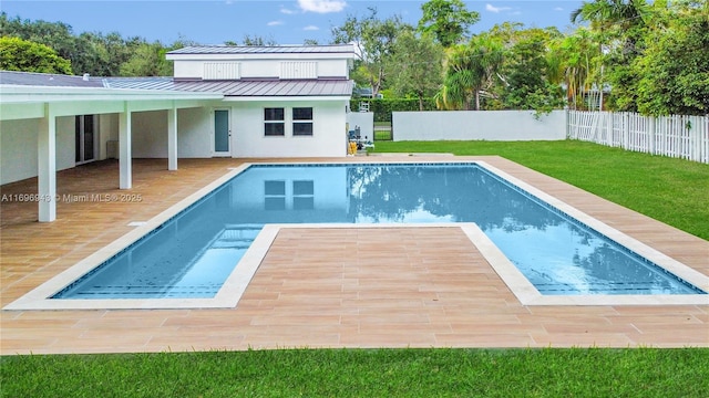 view of pool featuring a wooden deck and a lawn