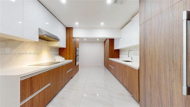 kitchen with black electric cooktop, tasteful backsplash, white cabinets, and ventilation hood