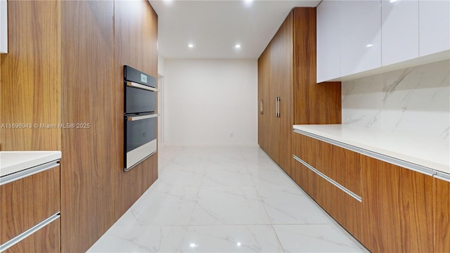 kitchen featuring double wall oven and white cabinets