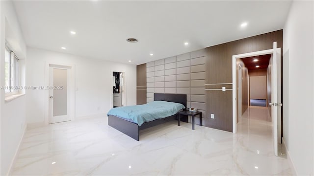 bedroom featuring wood walls