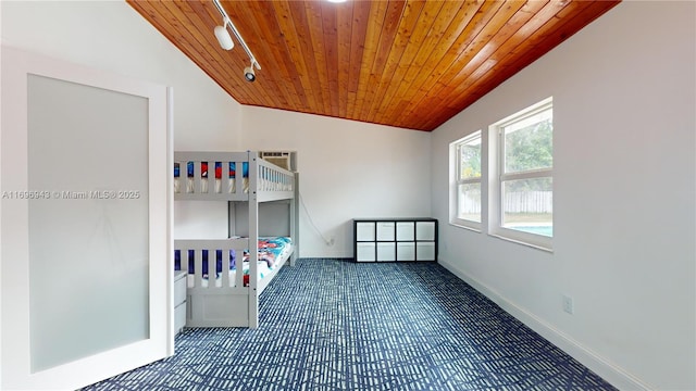 unfurnished bedroom featuring wood ceiling, track lighting, and vaulted ceiling