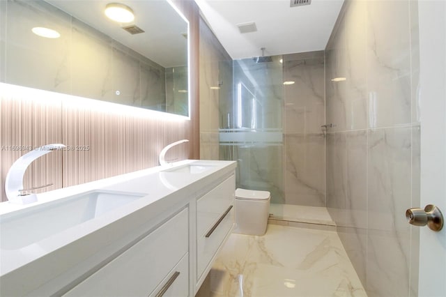 bathroom featuring vanity, tiled shower, and toilet