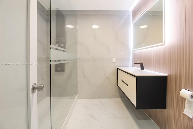 bathroom with vanity and tiled shower