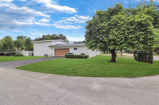 view of front facade with a garage and a front lawn