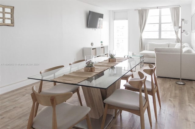 dining space with light wood-type flooring