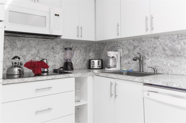 kitchen featuring white cabinets, white appliances, and sink