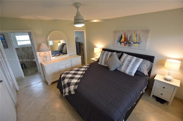 tiled bedroom featuring ceiling fan and connected bathroom