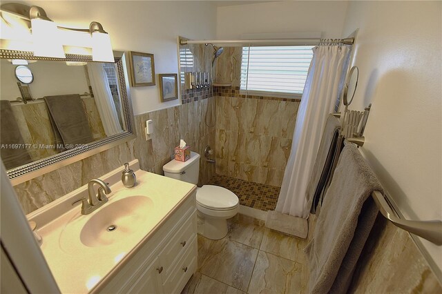 bathroom with toilet, vanity, tile walls, and walk in shower