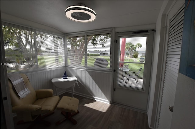 sunroom / solarium featuring lofted ceiling