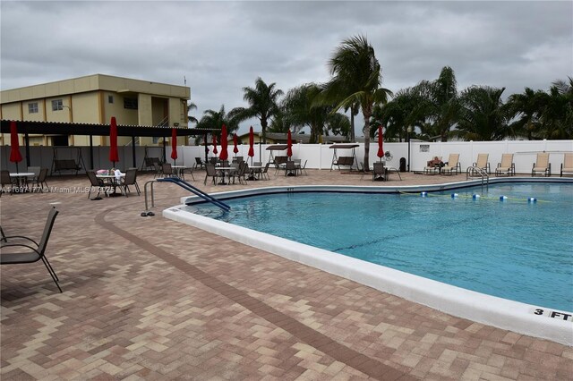 view of swimming pool with a patio area