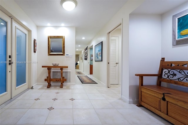 hall with light tile patterned floors