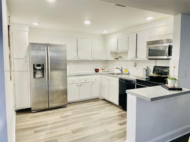 kitchen featuring black appliances, white cabinetry, sink, and light hardwood / wood-style flooring