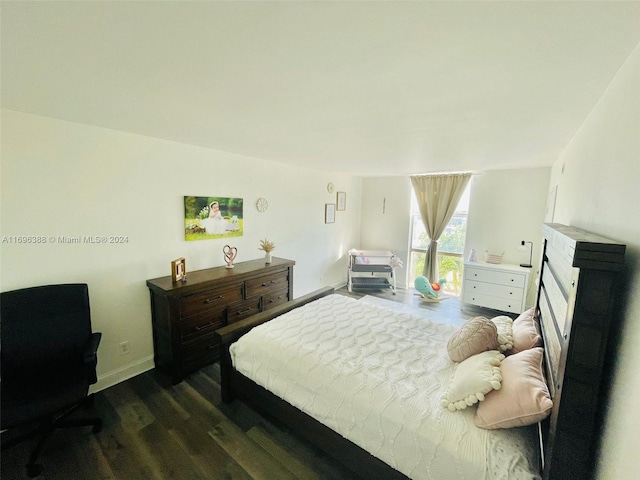 bedroom featuring dark hardwood / wood-style flooring