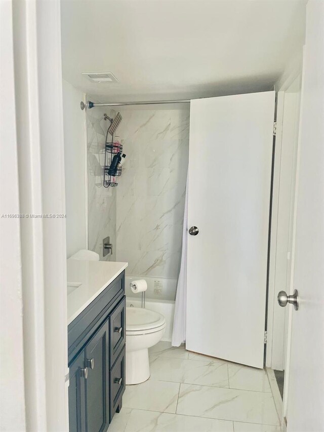 full bathroom featuring vanity, shower / bath combination with curtain, and toilet