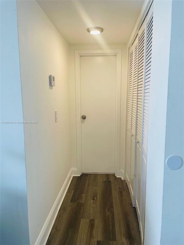 hallway with dark hardwood / wood-style floors