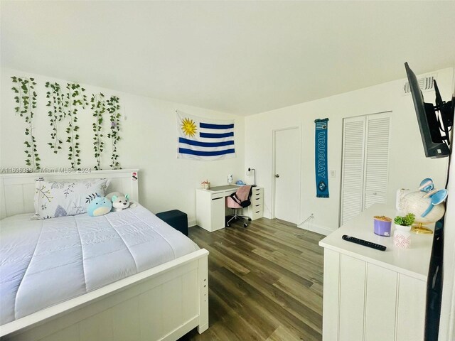 bedroom with dark hardwood / wood-style flooring