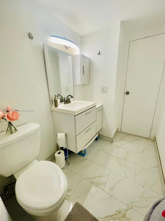 bathroom featuring vanity and toilet