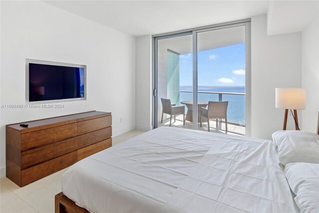 bedroom with access to outside, multiple windows, and light tile patterned flooring