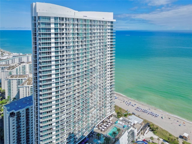 aerial view featuring a view of the beach and a water view