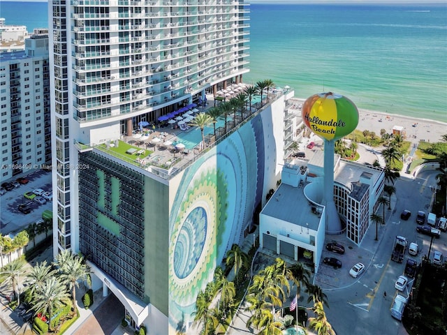 bird's eye view featuring a water view and a beach view