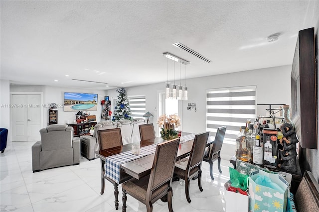 dining room with a textured ceiling