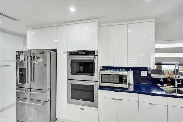 kitchen with sink, stainless steel appliances, and white cabinets