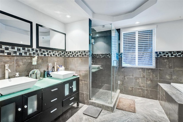 bathroom with vanity, tile walls, and an enclosed shower