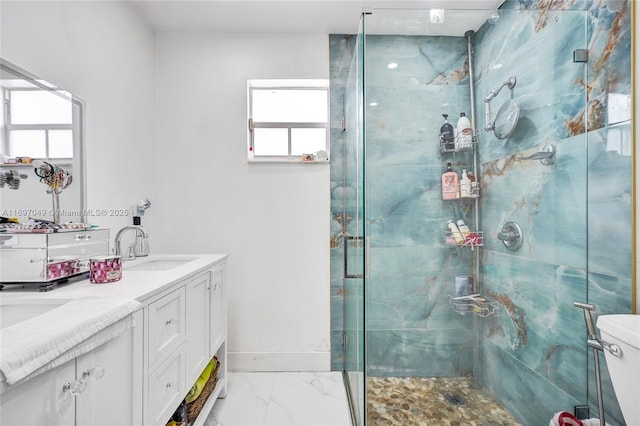 bathroom with vanity, toilet, and a shower with shower door