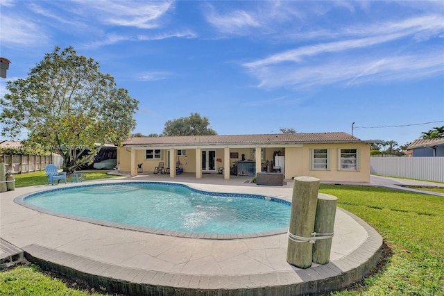 view of pool featuring a lawn and a patio area