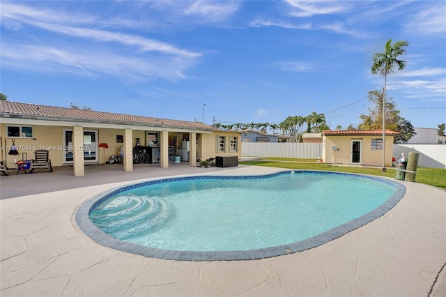 view of pool featuring an outdoor structure and a patio area