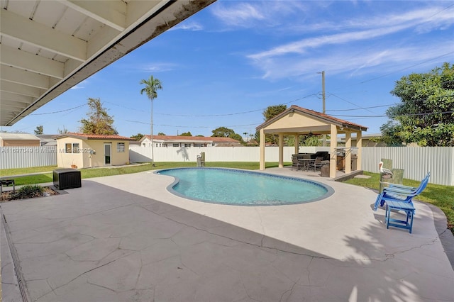 view of pool with a gazebo, a patio area, and an outbuilding