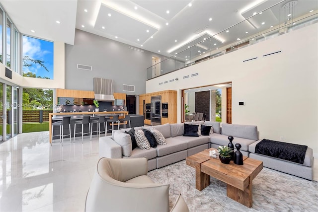 living room with a wealth of natural light and a high ceiling