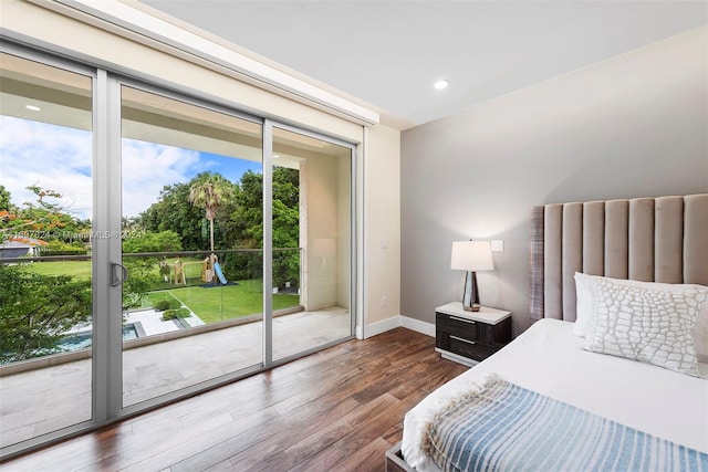 bedroom with access to outside and dark hardwood / wood-style floors