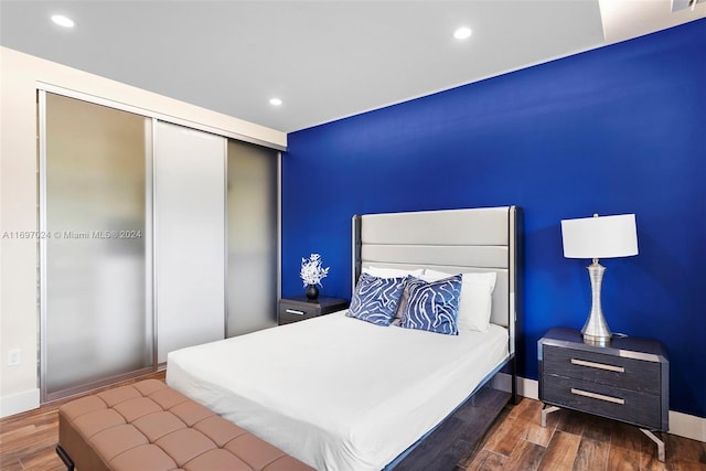 bedroom featuring a closet and dark hardwood / wood-style floors